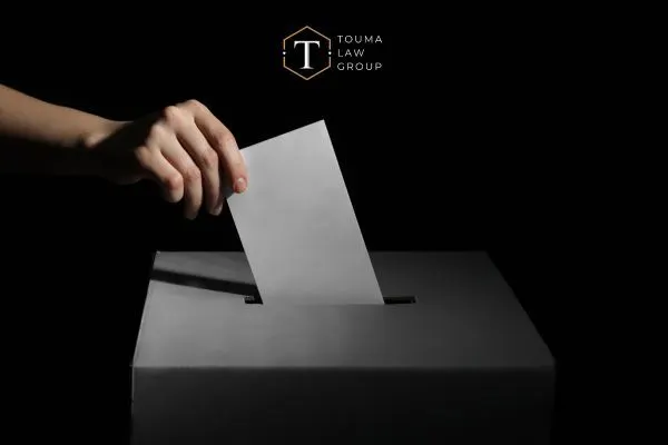 a person putting a vote in a ballot box