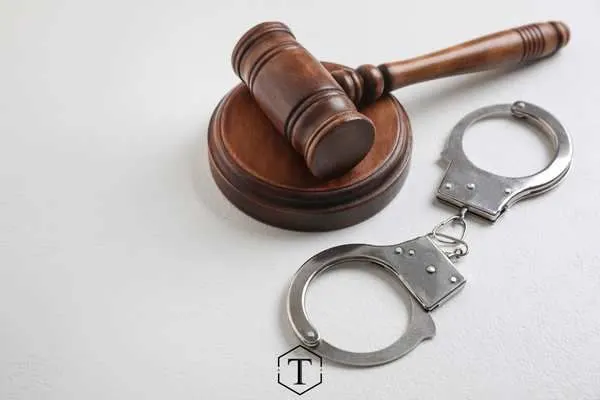 a gavel and handcuffs in front of a white background