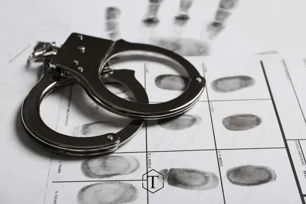 fingerprint records and handcuffs on a table