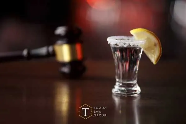 a gavel and shot on tequila on a desk