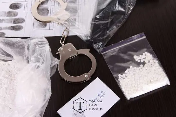 a large quantity of drugs and handcuffs on a table