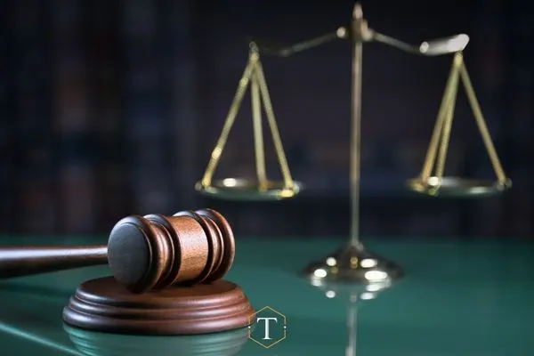 an attorneys desk with a gavel and scale on it
