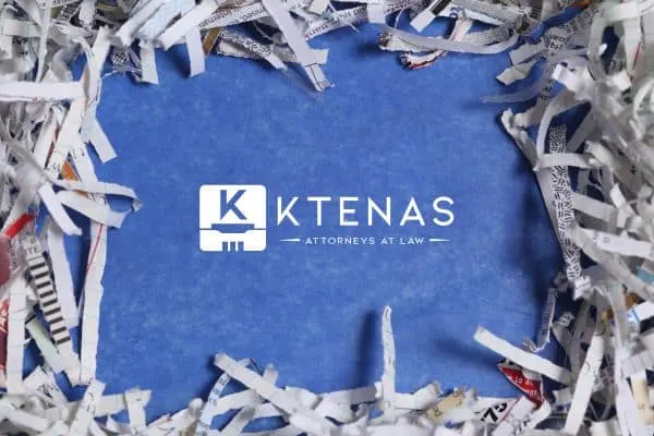 Ktenas law logo on blue background with paper around edges