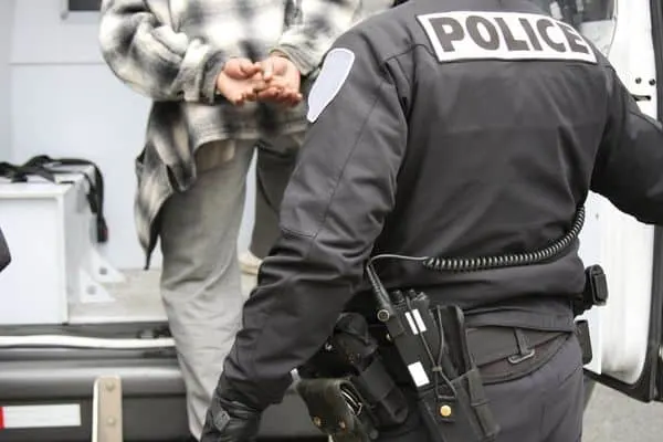 person being handcuffed into a police van, After You've Been Arrested