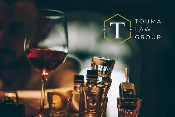 alcohol on a bar with a car key in a glass