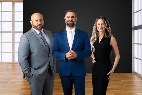 two male attorneys and one female attorney in office