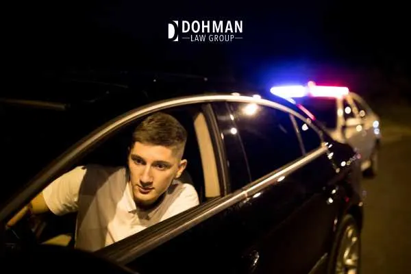 Man pulled over with patrol car with lights on behind him