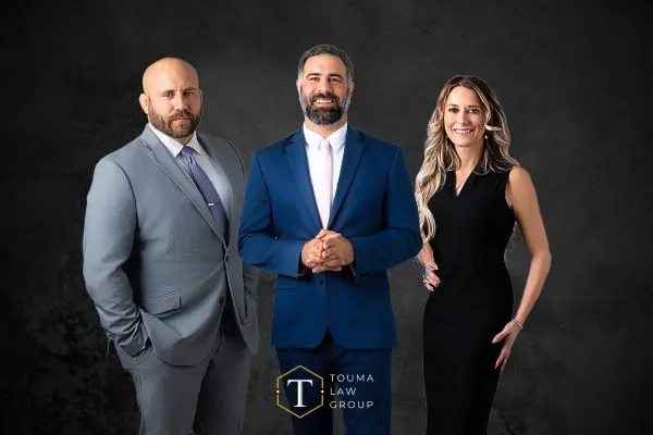 attorneys Jarrett, Adam, and Alissa standing together with black background