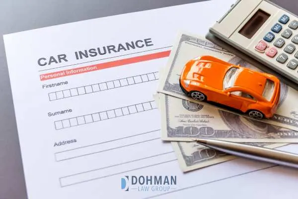 Car insurance application with money and a toy car