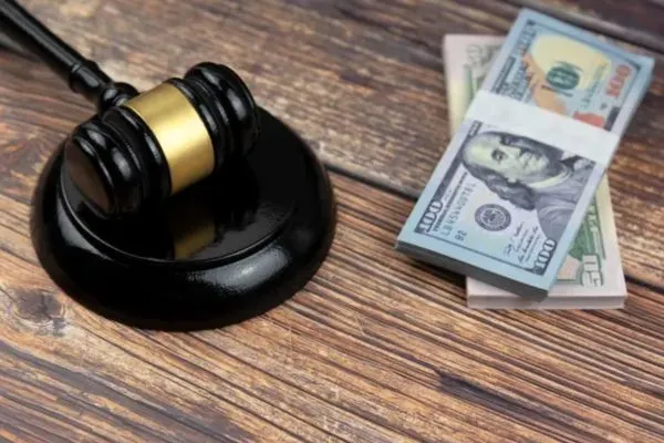 A judge's gavel and stacks of cash