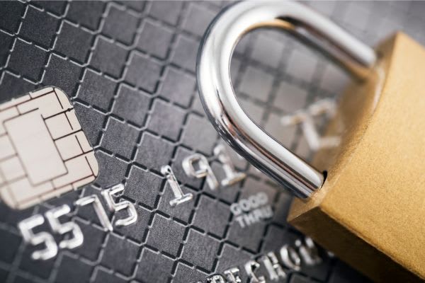 gold lock laying on credit card