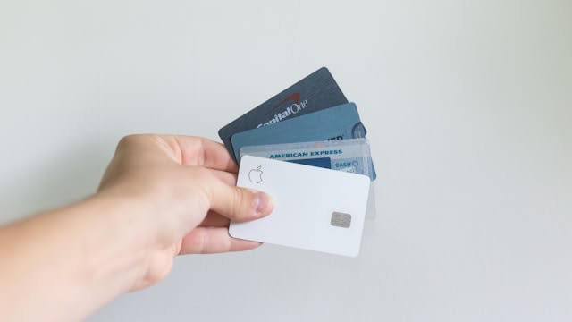 Hand holding 4 credit cards