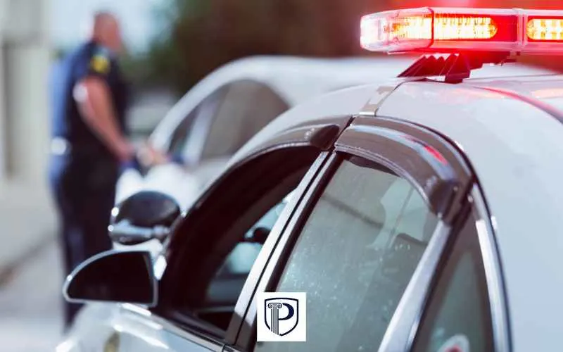 a police officer approaching a car after pulling the driver over