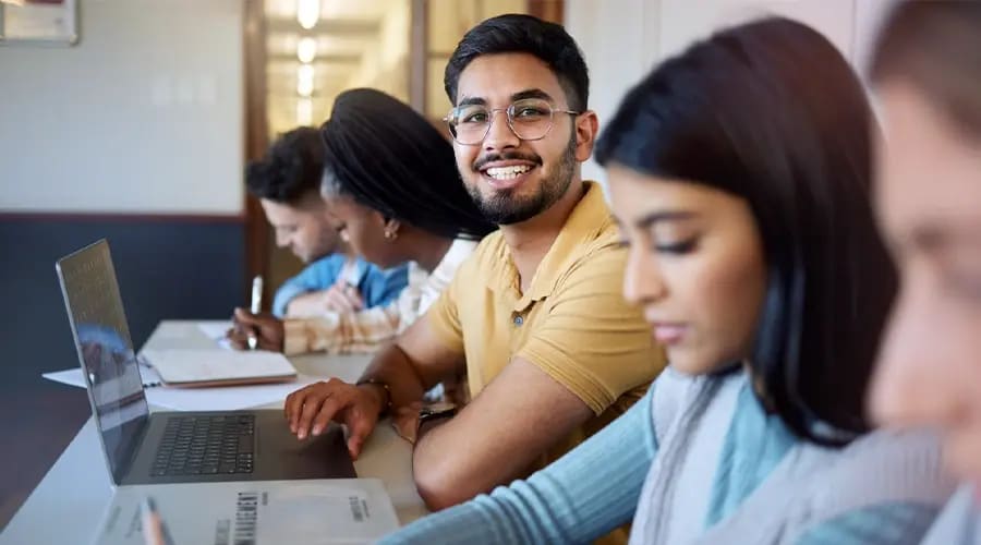 Top MBA Entrance Exams 2027 Students Preparing for Management Admissions Students preparing for Top MBA Entrance Exams 2027 with laptops and study materials in a classroom setting