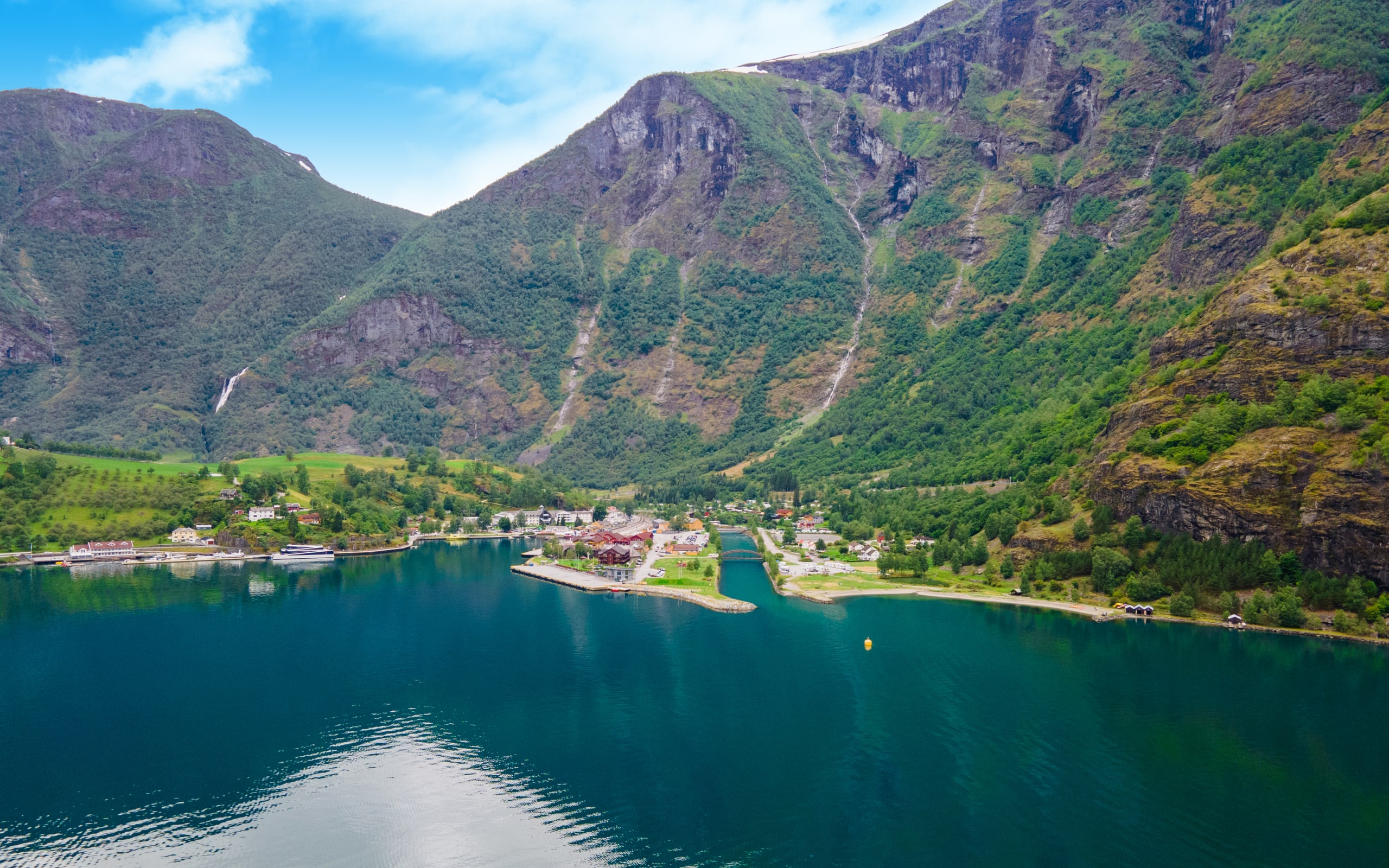 The harbor of Flåm with lush mountainsides