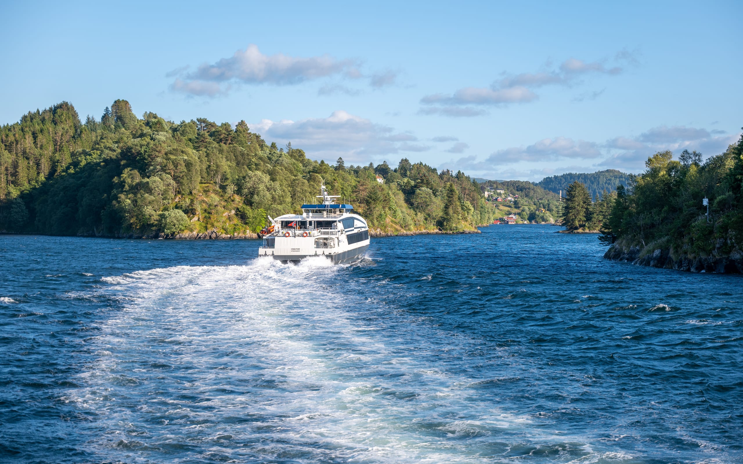 A fjord boat sailing through Alverstraumen heading for Bergen