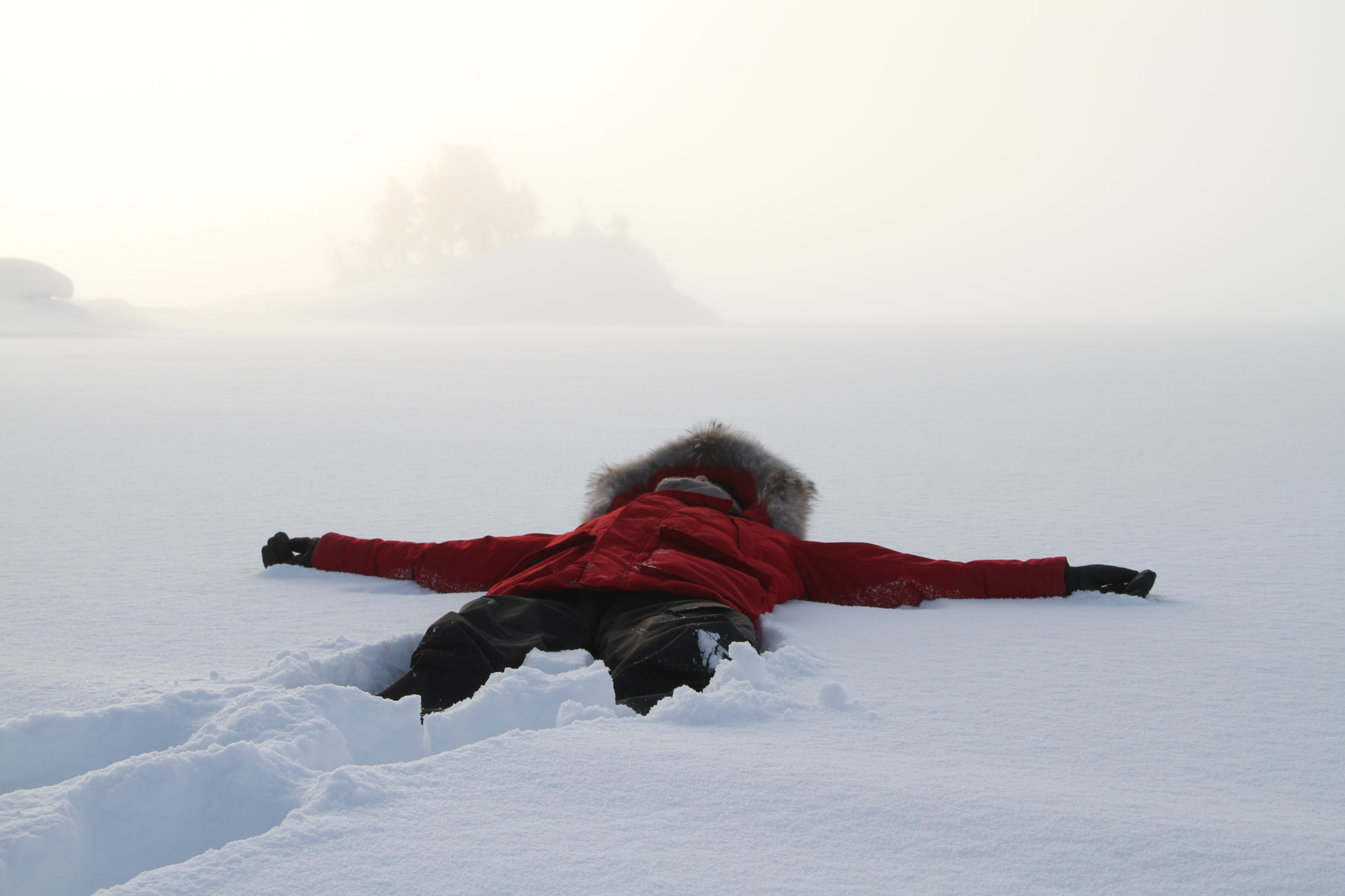 Man making snow angel in Jotunheimen