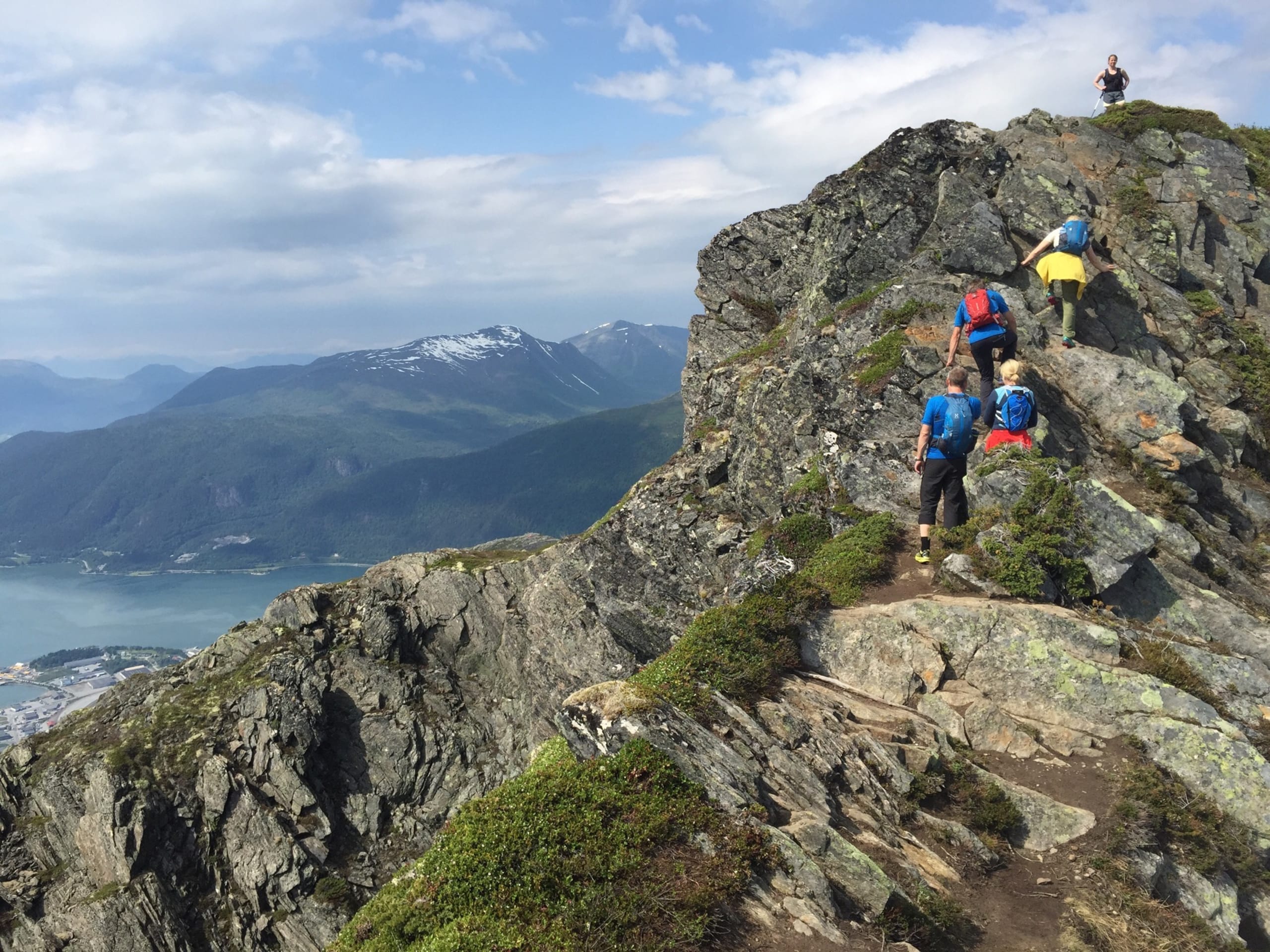 Hikers on top of Romsdalseggen mountain ridge