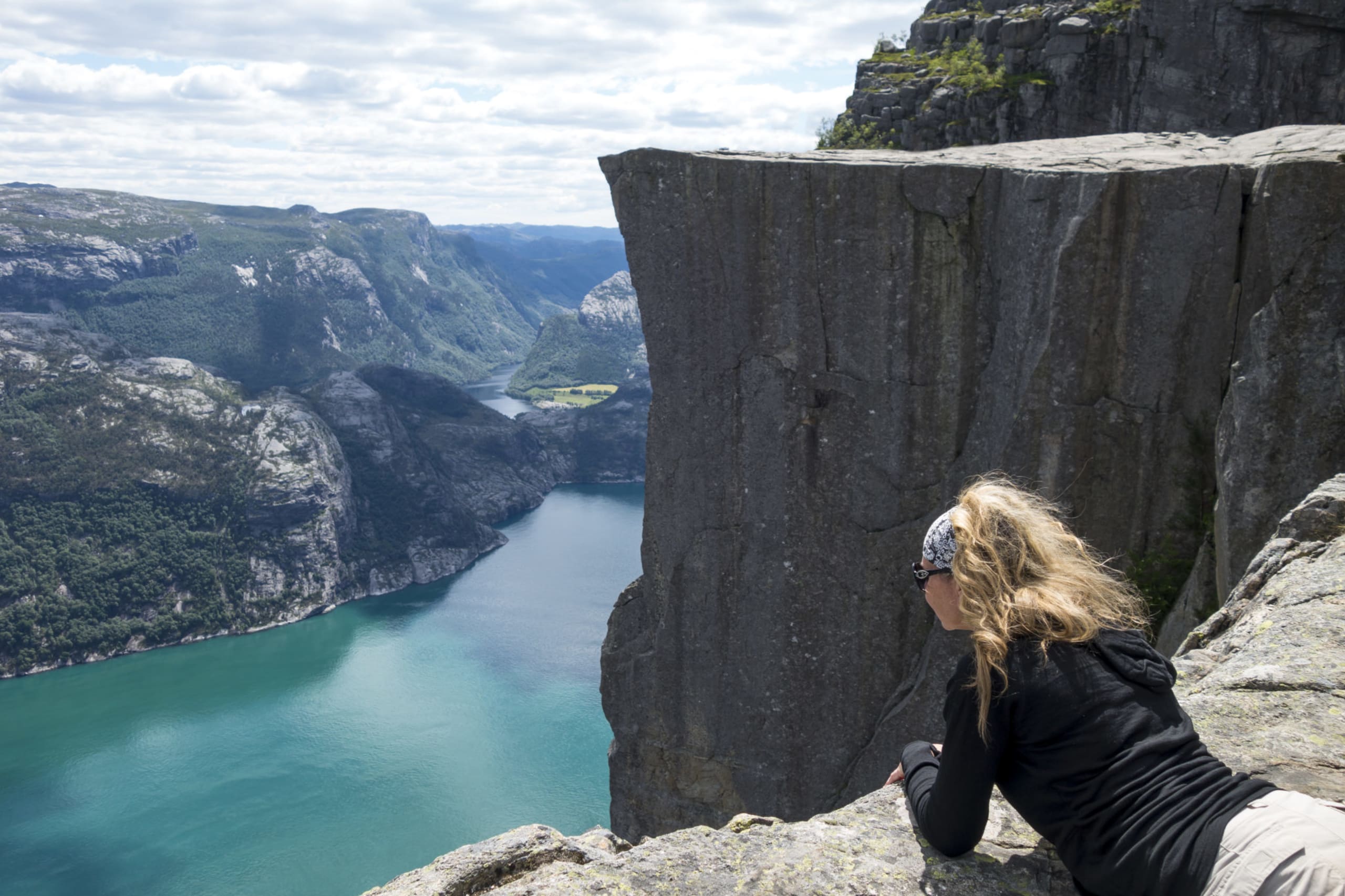 Woman leaning over the edge of Preikestolen
