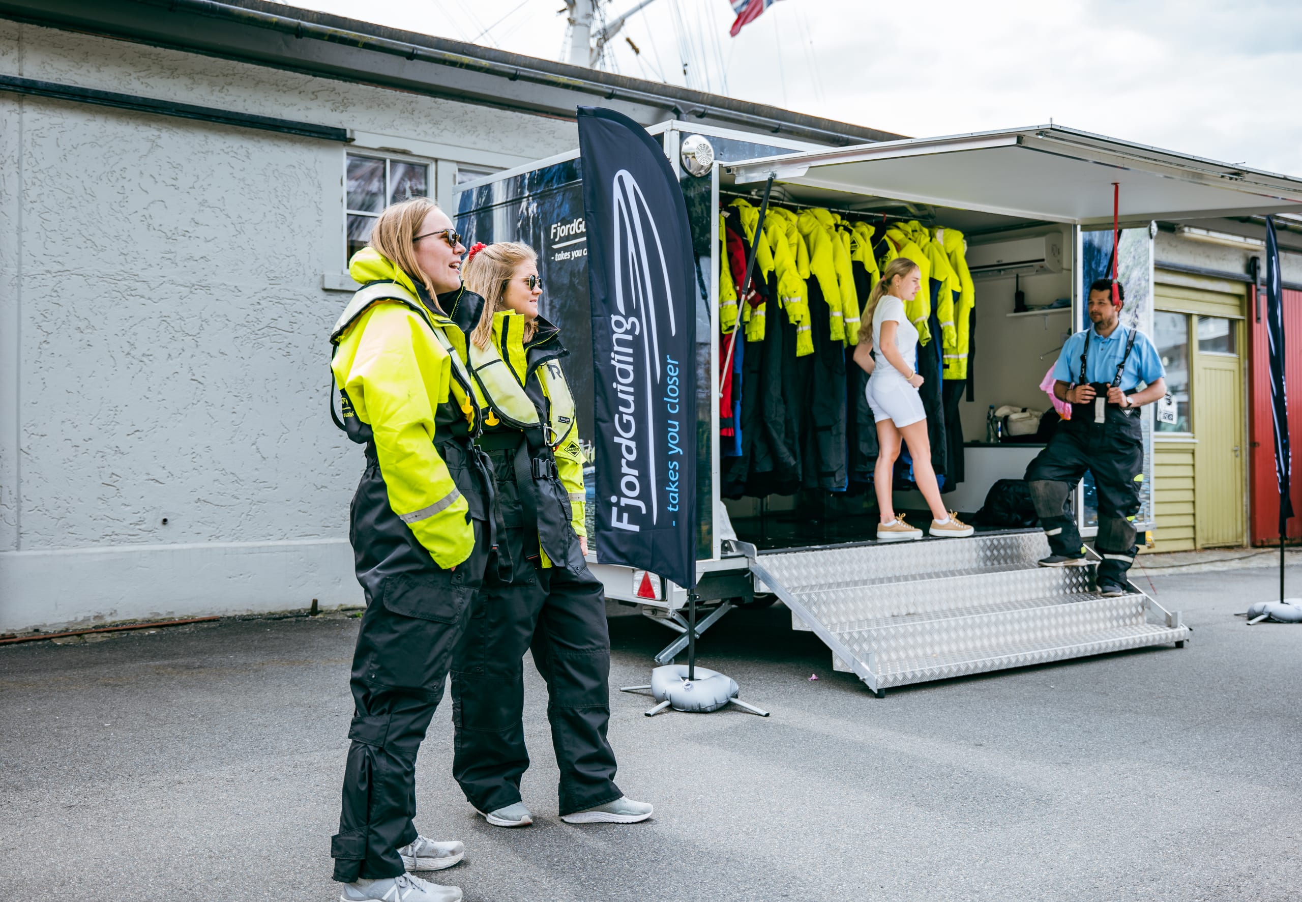 Girls dressed in safety suits next to Bergen RIB trailer