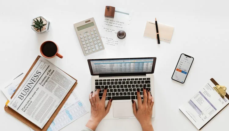 Small business owner researching accountants on laptop