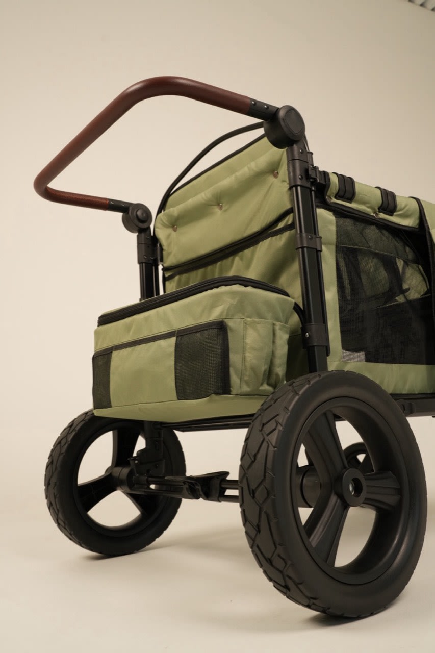 Large all-terrain wheels on a STROLLZ. stroller wagon designed for smooth rides across different surfaces.