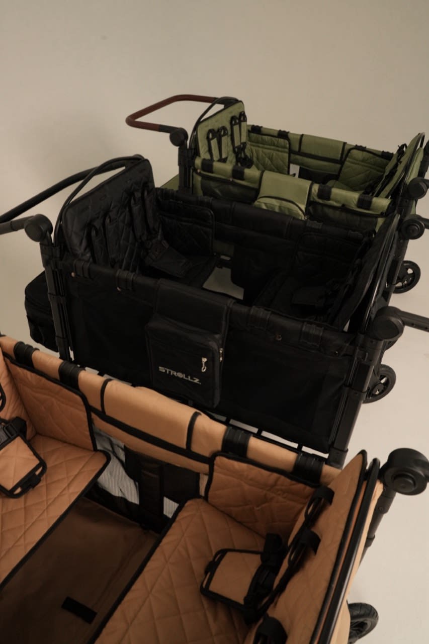 Three STROLLZ. stroller wagons in Urban Black, Desert Sand and Forest Green, showcasing the STROLLZ. collection for modern family life.