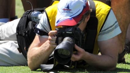 A photographer takes a close up photo of Tiger Woods's ball during the Pro-Am for the Australian Masters tournament at the Kingston Heath golf course, his first tournament in Australia for 11 years, in Melbourne on November 11, 2009. Woods, who is reportedly being paid three million US dollars to play in this week's European Tour co-sanctioned event, will attract massive public galleries at the Kingston Heath sandbelt course. All 25,000 tickets for each of the four days of the tournament were sold out early last month, with reports that officials are anticipating crowds of up to 15 deep behind the ropes following Woods. AFP PHOTO/William WEST (Photo credit should read WILLIAM WEST/AFP/Getty Images)