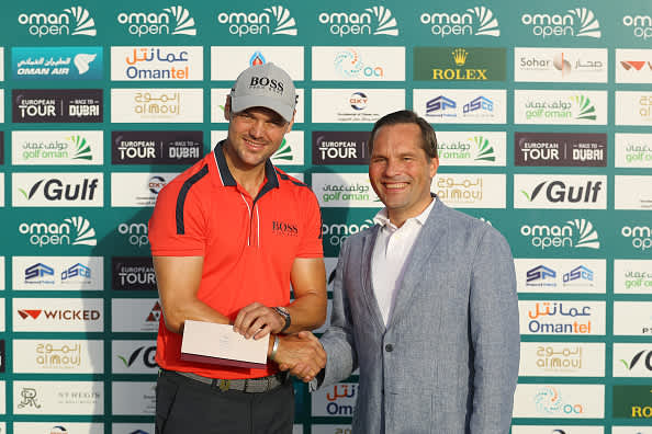 MUSCAT, OMAN - FEBRUARY 28: Martin Kaymer of Germany is presented with 7 nights for 2 in the Kempinksi Hotel, Muscat by Carsten Wiegand, General Manager of the hotel following Kaymer's hole in one on the 13th hole during Day 2 of the Oman Open at Al Mouj Golf Complex on February 28, 2020 in Muscat, Oman. (Photo by Warren Little/Getty Images)