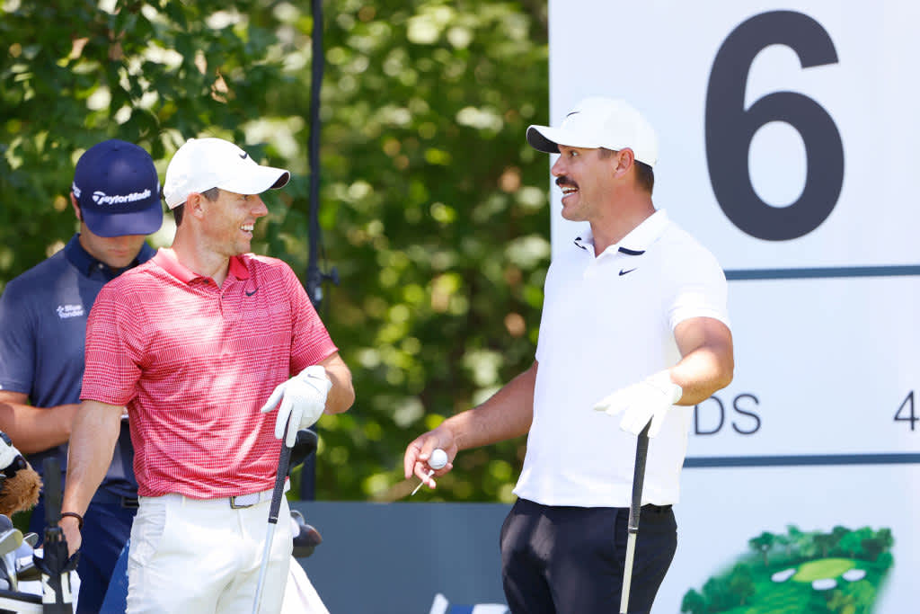 FORT WORTH, TEXAS - JUNE 11: Rory McIlroy of Northern Ireland and Brooks Koepka of the United States talk on the sixth tee during the first round of the Charles Schwab Challenge on June 11, 2020 at Colonial Country Club in Fort Worth, Texas. (Photo by Tom Pennington/Getty Images)