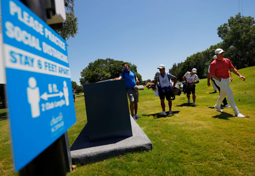 FORT WORTH, TEXAS - JUNE 11: Rory McIlroy of Northern Ireland walks past social distancing signage on his way to the eighth tee during the first round of the Charles Schwab Challenge on June 11, 2020 at Colonial Country Club in Fort Worth, Texas. (Photo by Tom Pennington/Getty Images)