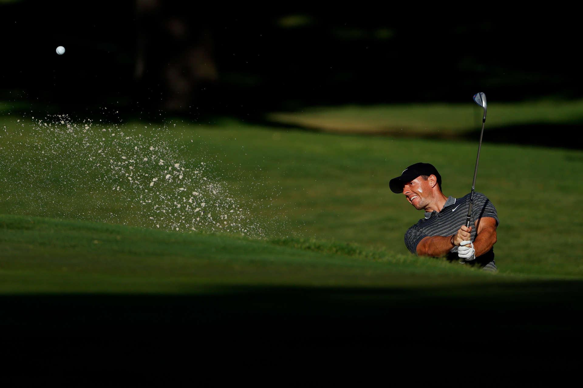 FORT WORTH, TEXAS - JUNE 12: Rory McIlroy of Northern Ireland plays a shot from a bunker on the 11th hole during the second round of the Charles Schwab Challenge on June 12, 2020 at Colonial Country Club in Fort Worth, Texas. (Photo by Tom Pennington/Getty Images)