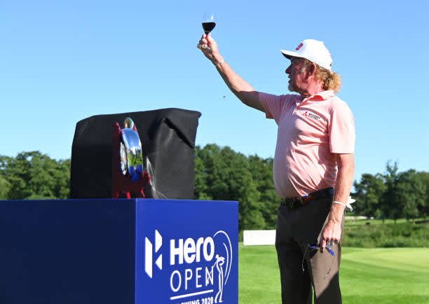 BIRMINGHAM, ENGLAND - JULY 30: Miguel Angel Jimenez of Spain raises a class after receiving a award after he made his 707th European tour start, a tour appearance record during Day One of the Hero Open at Marriott Forest of Arden on July 30, 2020 in Birmingham, England. (Photo by Ross Kinnaird/Getty Images)