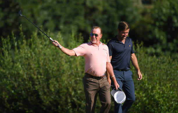 BIRMINGHAM, ENGLAND - JULY 30: Miguel Angel Jimenez of Spain waves his hat to players and staff who applaud him as he enters the 18th green with Robert Rock of England as he makes his 707th European tour start, a tour appearance record during Day One of the Hero Open at Marriott Forest of Arden on July 30, 2020 in Birmingham, England. (Photo by Ross Kinnaird/Getty Images)
