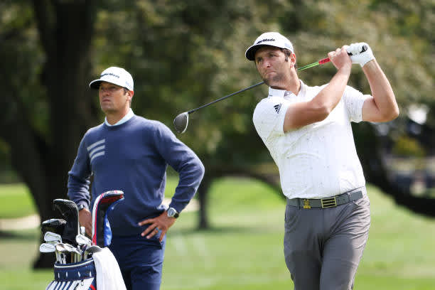 MAMARONECK, NEW YORK - SEPTEMBER 15: Jon Rahm (R) of Spain plays a tee shot as caddie Adam Hayes (L) looks on during a practice round prior to the 120th U.S. Open Championship on September 15, 2020 at Winged Foot Golf Club in Mamaroneck, New York. (Photo by Jamie Squire/Getty Images)