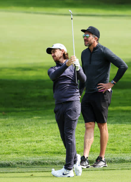 MAMARONECK, NEW YORK - SEPTEMBER 15: Tommy Fleetwood of England plays a shot as caddie Ian Finnis looks on during a practice round prior to the 120th U.S. Open Championship on September 15, 2020 at Winged Foot Golf Club in Mamaroneck, New York. (Photo by Jamie Squire/Getty Images)