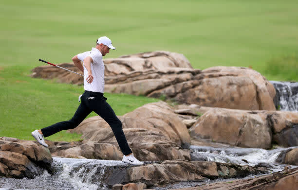 MALELANE, SOUTH AFRICA - NOVEMBER 27: Chris Wood of England jumps over the river between the 9th and 18th holes during the second round of the Alfred Dunhill Championship at Leopard Creek Country Golf Club on November 27, 2020 in Malelane, South Africa. (Photo by Richard Heathcote/Getty Images)