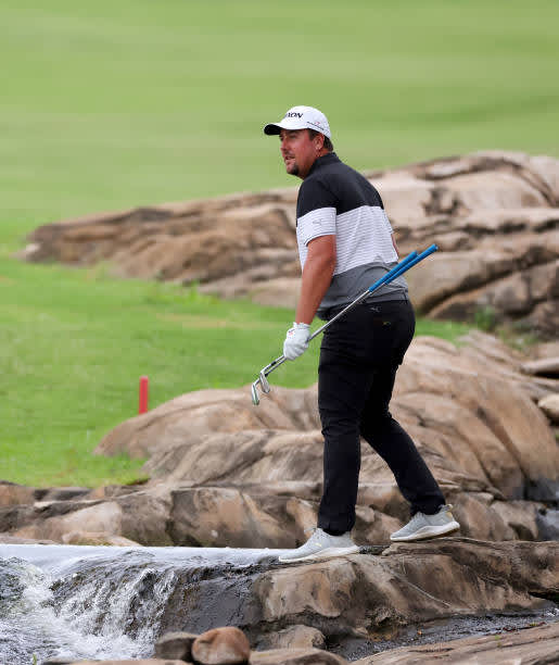 MALELANE, SOUTH AFRICA - NOVEMBER 27: AHLERS, Jaco Ahlers of South Africa jumps over the river between the 9th and 18th holes during the second round of the Alfred Dunhill Championship at Leopard Creek Country Golf Club on November 27, 2020 in Malelane, South Africa. (Photo by Richard Heathcote/Getty Images)