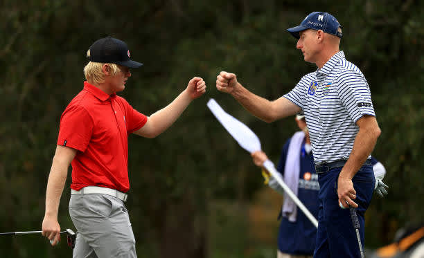ORLANDO, FLORIDA - DECEMBER 20: Jim Furyk and son Tanner Furyk fist bump `on the 14th hole during the final round of the PNC Championship at the Ritz Carlton Golf Club on December 20, 2020 in Orlando, Florida. (Photo by Mike Ehrmann/Getty Images)
