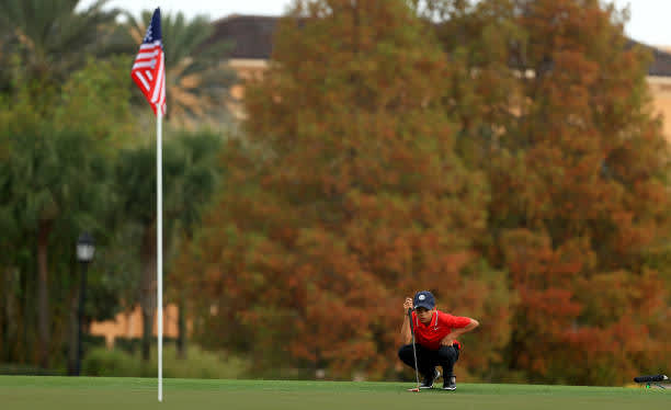 ORLANDO, FLORIDA - DECEMBER 20: Tiger Woods of the United States' son Charlie Woods line up a putt on the 18th hole during the final round of the PNC Championship at the Ritz Carlton Golf Club on December 20, 2020 in Orlando, Florida. (Photo by Mike Ehrmann/Getty Images)