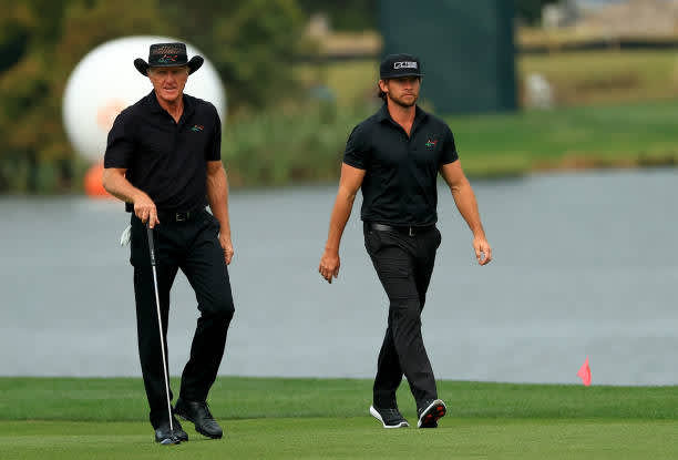 ORLANDO, FLORIDA - DECEMBER 20: Greg Norman and son Greg Norman Jr. walk up the 18th hole during the final round of the PNC Championship at the Ritz Carlton Golf Club on December 20, 2020 in Orlando, Florida. (Photo by Mike Ehrmann/Getty Images)