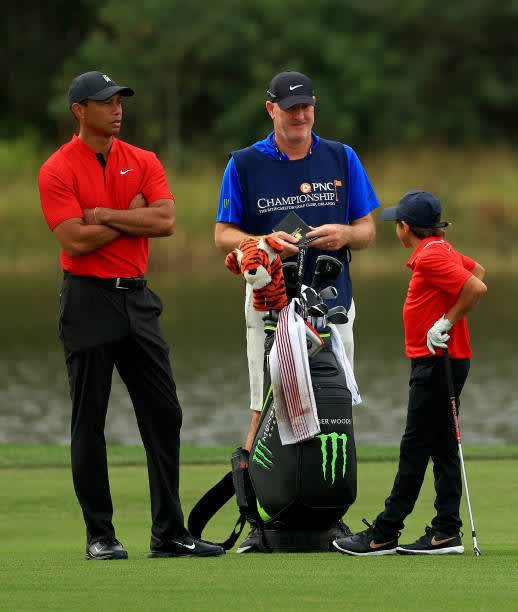 ORLANDO, FLORIDA - DECEMBER 20: Tiger Woods of the United States and son Charlie Woods wait to hits their approach shot with caddie Joe LaCava during the final round of the PNC Championship at the Ritz Carlton Golf Club on December 20, 2020 in Orlando, Florida. (Photo by Mike Ehrmann/Getty Images)
