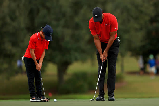 ORLANDO, FLORIDA - DECEMBER 20: Tiger Woods of the United States and son Charlie Woods practice putting on the 14th hole during the final round of the PNC Championship at the Ritz Carlton Golf Club on December 20, 2020 in Orlando, Florida. (Photo by Mike Ehrmann/Getty Images)
