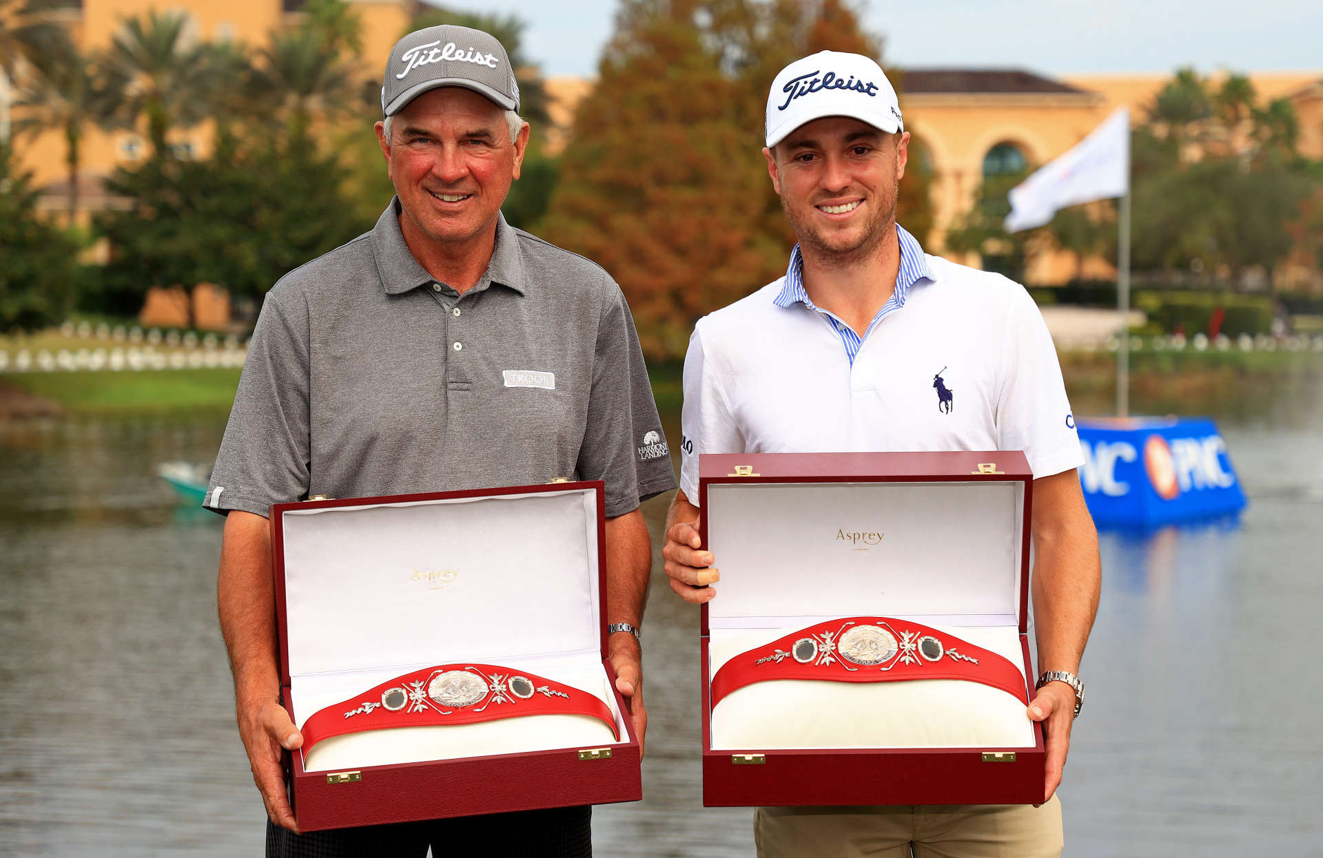 ORLANDO, FLORIDA - DECEMBER 20: Justin Thomas of the United States and dad Mike Thomas pose with the trophy after winning the PNC Championship at the Ritz Carlton Golf Club on December 20, 2020 in Orlando, Florida. (Photo by Mike Ehrmann/Getty Images)