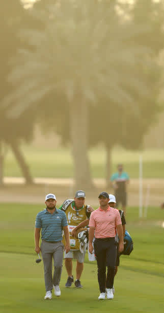 ABU DHABI, UNITED ARAB EMIRATES - JANUARY 23: Rory McIlroy of Northern Ireland and Tyrrell Hatton of England walk on the 18th hole during the third round of the Abu Dhabi HSBC Championship at Abu Dhabi Golf Club on January 23, 2021 in Abu Dhabi, United Arab Emirates. (Photo by Warren Little/Getty Images)