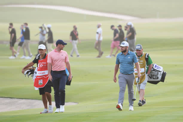 ABU DHABI, UNITED ARAB EMIRATES - JANUARY 23: Rory McIlroy of Northern Ireland and Tyrrell Hatton of England walk on the 18th hole during Day Three of the Abu Dhabi HSBC Championship at Abu Dhabi Golf Club on January 23, 2021 in Abu Dhabi, United Arab Emirates. (Photo by Ross Kinnaird/Getty Images)
