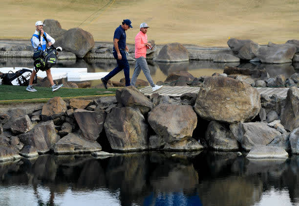 LA QUINTA, CALIFORNIA - JANUARY 22: Rickie Fowler and Phil Mickelson walk across the bridge on the 17th hole during the second round of The American Express tournament on the Stadium course at PGA West on January 22, 2021 in La Quinta, California. (Photo by Harry How/Getty Images)