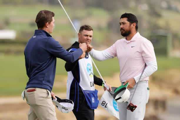 PEBBLE BEACH, CALIFORNIA - FEBRUARY 14: Maverick McNealy of the United States and Jason Day of Australia bump fists after finishing on the 18th green during the final round of the AT&T Pebble Beach Pro-Am at Pebble Beach Golf Links on February 14, 2021 in Pebble Beach, California. (Photo by Ezra Shaw/Getty Images)