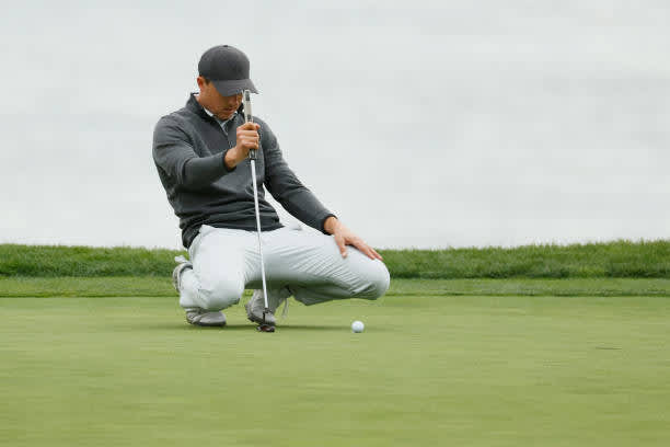 PEBBLE BEACH, CALIFORNIA - FEBRUARY 14: Jordan Spieth of the United States lines up a putt on the 18th green during the final round of the AT&T Pebble Beach Pro-Am at Pebble Beach Golf Links on February 14, 2021 in Pebble Beach, California. (Photo by Steph Chambers/Getty Images)