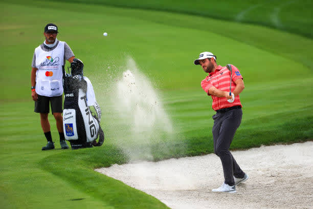 ORLANDO, FLORIDA - MARCH 06: Corey Conners of Canada plays a shot from a bunker on the 18th hole during the third round of the Arnold Palmer Invitational Presented by MasterCard at the Bay Hill Club and Lodge on March 06, 2021 in Orlando, Florida. (Photo by Mike Ehrmann/Getty Images)